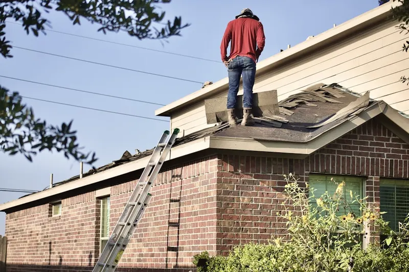 Professional roofer working on a residential roof in Logan Square